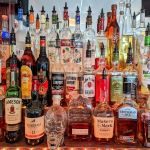 A bar with many different types of liquor.
