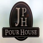 J h pour house logo on a glass door.